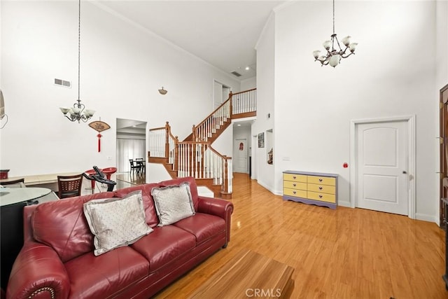 3453 Ivar Ave, Rosemead, CA 91770 - living area featuring a chandelier, a high ceiling, wood finished floors, stairway, and crown molding