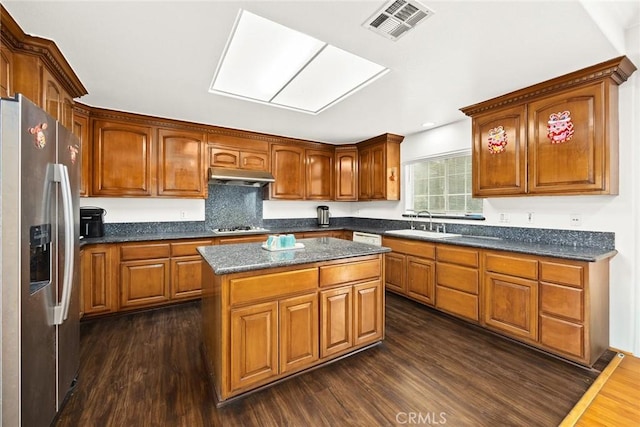 3453 Ivar Ave, Rosemead, CA 91770 - kitchen with stainless steel fridge, under cabinet range hood, dark wood-type flooring, brown cabinetry, and gas cooktop