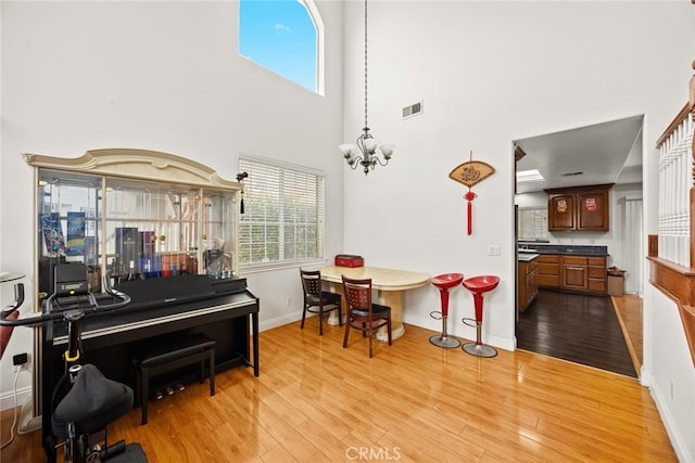 3453 Ivar Ave, Rosemead, CA 91770 - dining area featuring light wood-style flooring, a towering ceiling, and a chandelier
