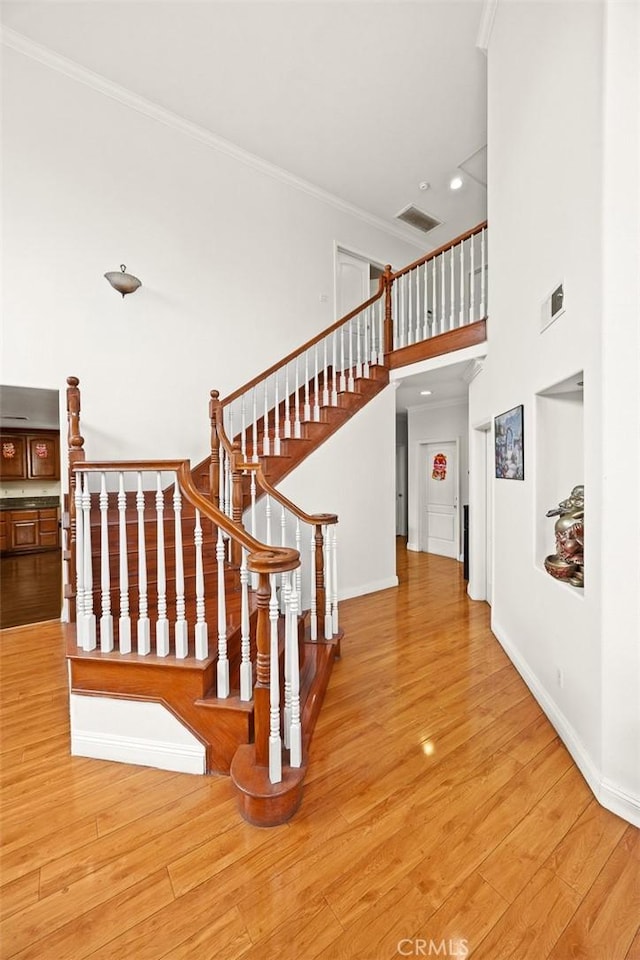 3453 Ivar Ave, Rosemead, CA 91770 - stairway with crown molding, wood finished floors, recessed lighting, and a towering ceiling