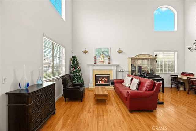 3453 Ivar Ave, Rosemead, CA 91770 - living area featuring a towering ceiling, a glass covered fireplace, plenty of natural light, and wood finished floors
