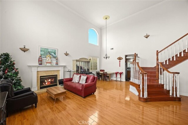 3453 Ivar Ave, Rosemead, CA 91770 - living area with a tiled fireplace, wood finished floors, stairway, and a towering ceiling