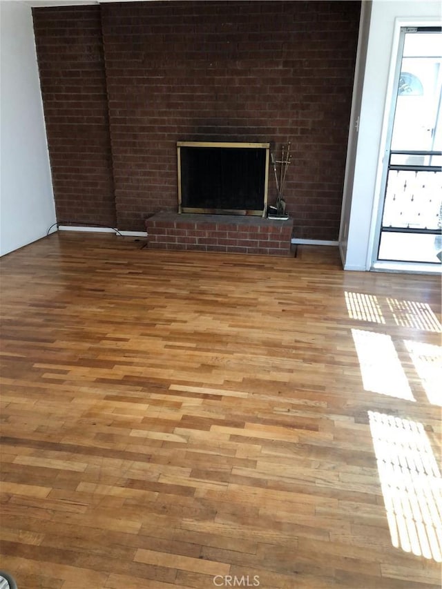 12961 Panama St, Los Angeles, CA 90066 - unfurnished living room with light wood-style floors and a brick fireplace