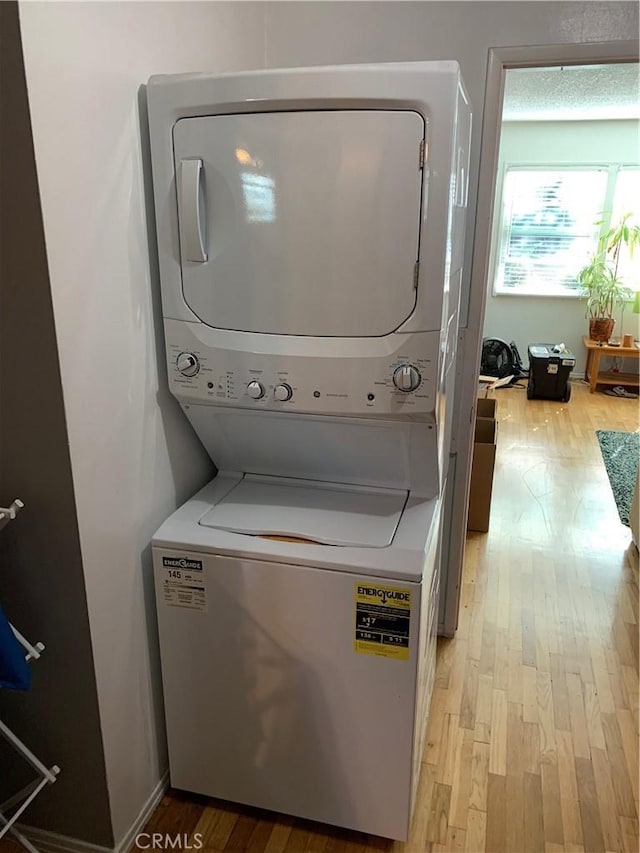 12961 Panama St, Los Angeles, CA 90066 - laundry room featuring stacked washer / drying machine and light wood-style flooring