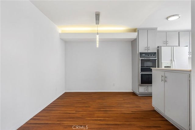 5429 Newcastle Ave Unit 309, Encino, CA 91316 - kitchen featuring white refrigerator with ice dispenser, dark wood finished floors, and pendant lighting
