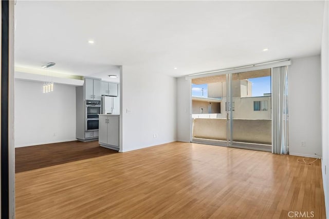 5429 Newcastle Ave Unit 309, Encino, CA 91316 - unfurnished living room with wood finished floors and recessed lighting