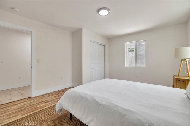 123 W 56th St, Los Angeles, CA 90037 - bedroom with wood finished floors and a closet