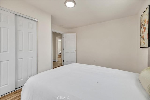 123 W 56th St, Los Angeles, CA 90037 - bedroom with wood finished floors and a closet