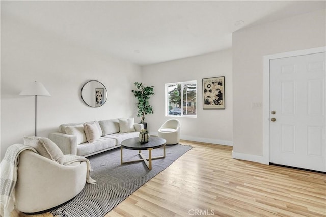 123 W 56th St, Los Angeles, CA 90037 - living area with light wood-style floors and baseboards
