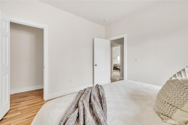 123 W 56th St, Los Angeles, CA 90037 - bedroom featuring wood finished floors and baseboards
