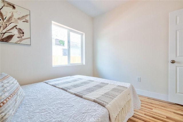 123 W 56th St, Los Angeles, CA 90037 - bedroom with wood finished floors and baseboards
