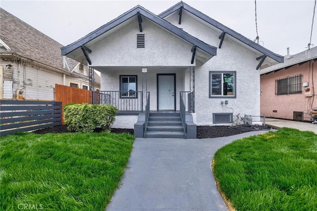 123 W 56th St, Los Angeles, CA 90037 - bungalow-style home with stucco siding and a porch