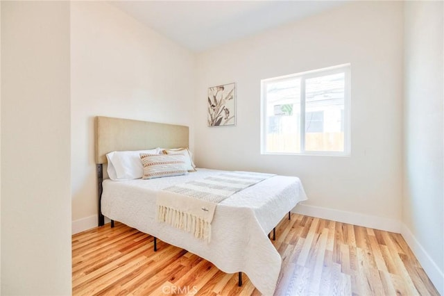 123 W 56th St, Los Angeles, CA 90037 - bedroom featuring wood finished floors and baseboards