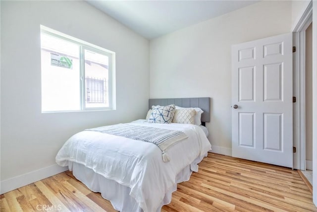 123 W 56th St, Los Angeles, CA 90037 - bedroom featuring wood finished floors and baseboards