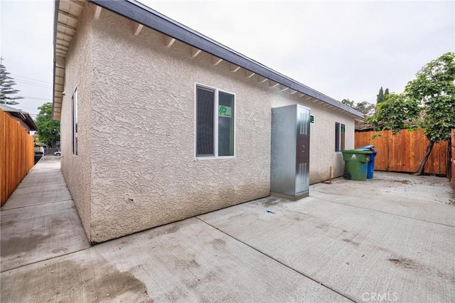123 W 56th St, Los Angeles, CA 90037 - back of house with stucco siding and a patio