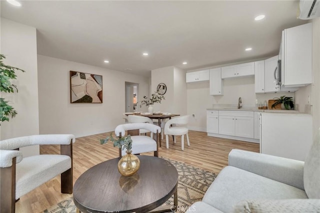 123 W 56th St, Los Angeles, CA 90037 - living area with a wall mounted AC, light wood-type flooring, and recessed lighting