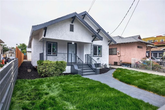 123 W 56th St, Los Angeles, CA 90037 - bungalow featuring stucco siding and covered porch
