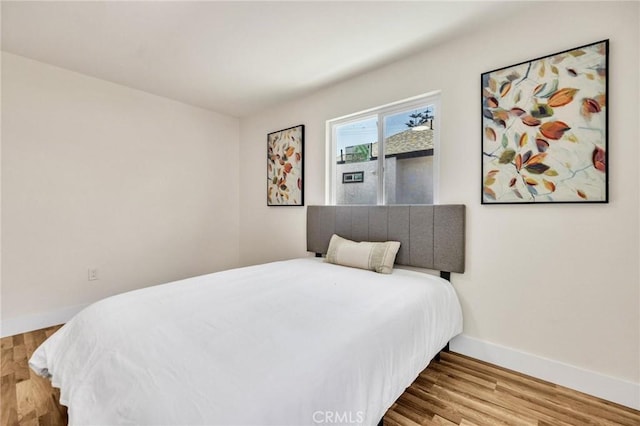 123 W 56th St, Los Angeles, CA 90037 - bedroom with wood finished floors