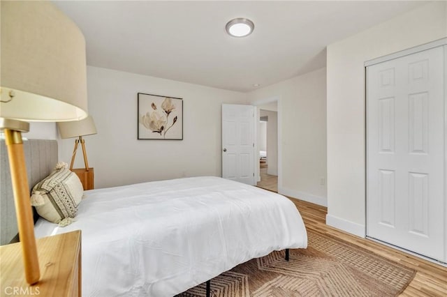 123 W 56th St, Los Angeles, CA 90037 - bedroom featuring wood finished floors and baseboards