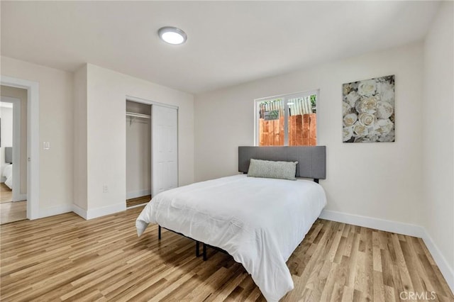 123 W 56th St, Los Angeles, CA 90037 - bedroom featuring a closet and light wood-type flooring