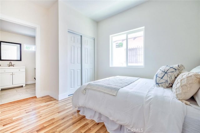 123 W 56th St, Los Angeles, CA 90037 - bedroom featuring light wood-style floors and a closet
