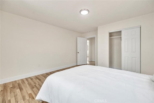 123 W 56th St, Los Angeles, CA 90037 - bedroom with wood finished floors and a closet