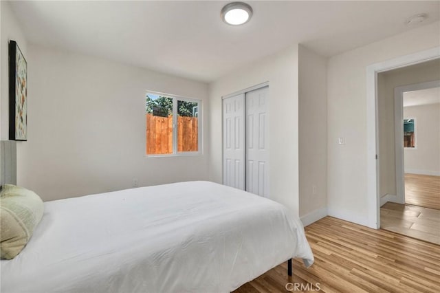 123 W 56th St, Los Angeles, CA 90037 - bedroom with wood finished floors and a closet