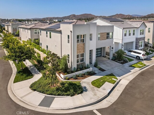 101 Mulberry Dr, Lake Forest, CA 92630 - view of front facade with a residential view, concrete driveway, a garage, and stucco siding