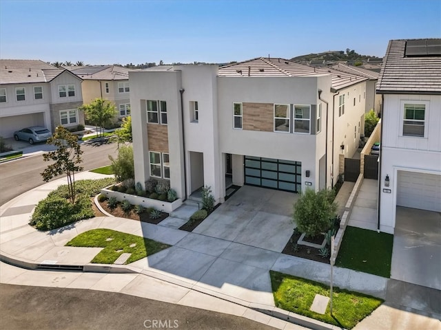 101 Mulberry Dr, Lake Forest, CA 92630 - view of front of property with stucco siding, a garage, driveway, and a residential view