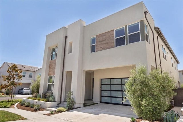 101 Mulberry Dr, Lake Forest, CA 92630 - view of front of home featuring stucco siding, a garage, and concrete driveway