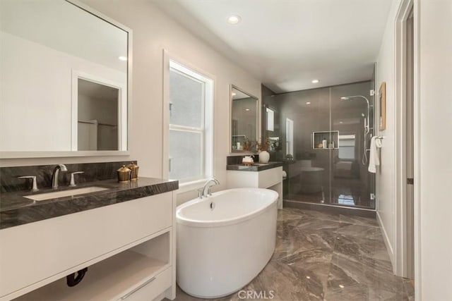 101 Mulberry Dr, Lake Forest, CA 92630 - full bath featuring marble tiled flooring, vanity, a stall shower, a freestanding tub, and recessed lighting
