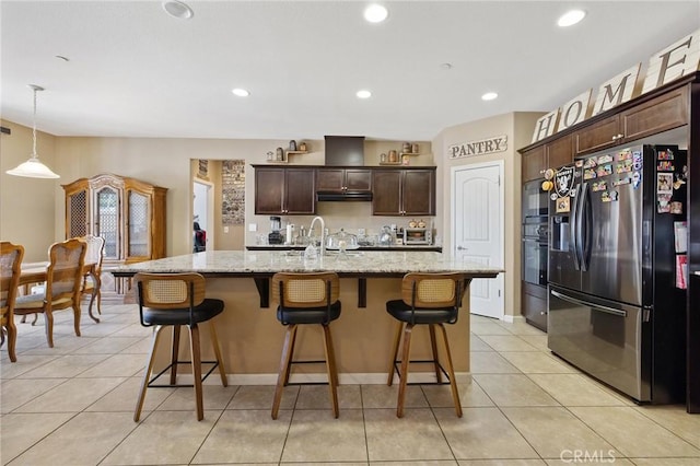 863 Legacy Dr, Lemoore, CA 93245 - kitchen featuring stainless steel refrigerator with ice dispenser, dark brown cabinetry, a breakfast bar, light tile patterned floors, and recessed lighting
