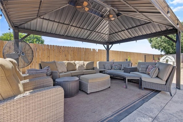 863 Legacy Dr, Lemoore, CA 93245 - fenced backyard with an outdoor hangout area, a gazebo, and ceiling fan