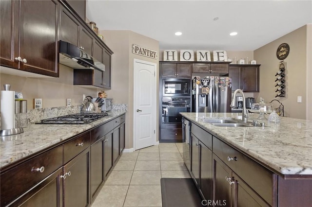863 Legacy Dr, Lemoore, CA 93245 - kitchen with black appliances, light tile patterned floors, dark brown cabinets, light stone countertops, and recessed lighting