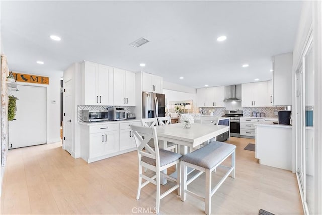 3208 Calle Grande, San Clemente, CA 92672 - kitchen featuring wall chimney exhaust hood, appliances with stainless steel finishes, backsplash, light countertops, and recessed lighting