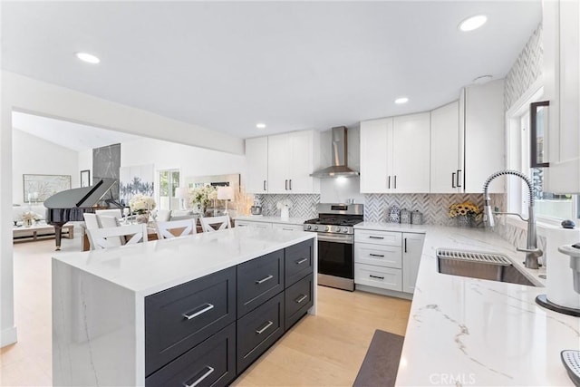 3208 Calle Grande, San Clemente, CA 92672 - kitchen with gas range, wall chimney range hood, white cabinetry, tasteful backsplash, and recessed lighting