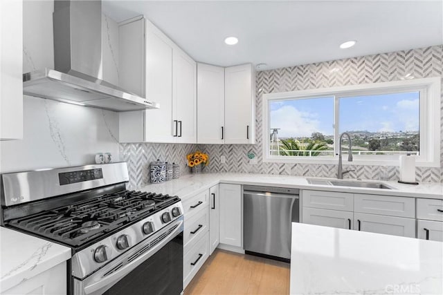3208 Calle Grande, San Clemente, CA 92672 - kitchen with appliances with stainless steel finishes, wall chimney exhaust hood, white cabinets, decorative backsplash, and light stone countertops