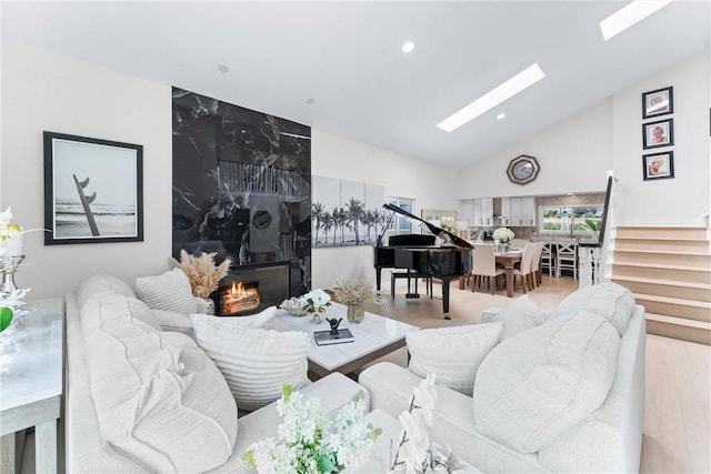 3208 Calle Grande, San Clemente, CA 92672 - living room featuring a skylight, wood finished floors, stairs, recessed lighting, and high vaulted ceiling