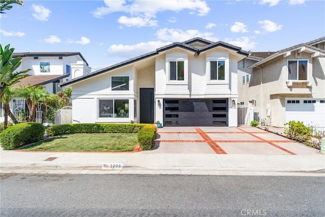 3208 Calle Grande, San Clemente, CA 92672 - view of front facade with stucco siding, a garage, concrete driveway, and a gate
