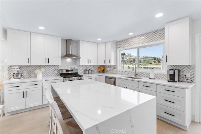 3208 Calle Grande, San Clemente, CA 92672 - kitchen featuring wall chimney exhaust hood, stainless steel appliances, a kitchen island, backsplash, and recessed lighting