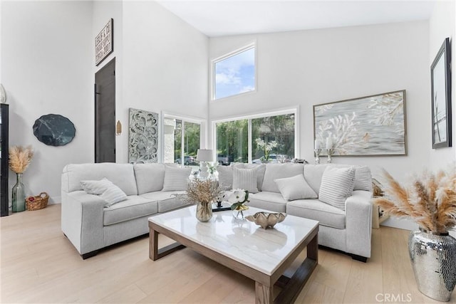 3208 Calle Grande, San Clemente, CA 92672 - living area featuring plenty of natural light, a towering ceiling, and light wood-style floors