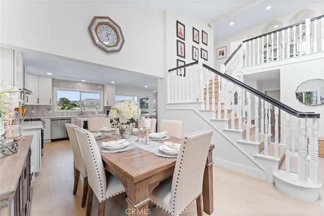 3208 Calle Grande, San Clemente, CA 92672 - dining area with stairs, light wood-type flooring, recessed lighting, and a towering ceiling