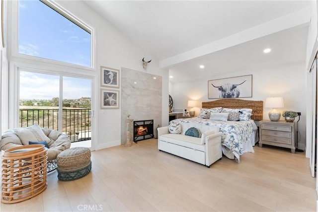 3208 Calle Grande, San Clemente, CA 92672 - bedroom featuring access to outside, light wood-style floors, high vaulted ceiling, recessed lighting, and a high end fireplace