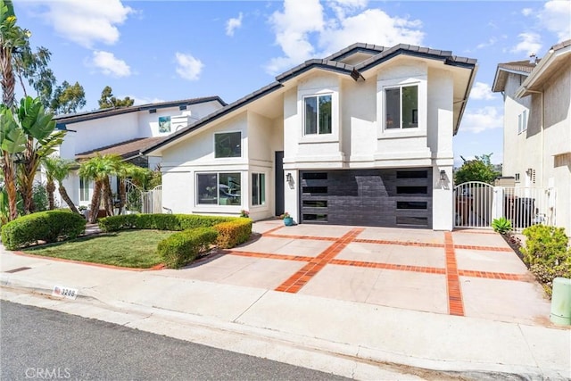 3208 Calle Grande, San Clemente, CA 92672 - contemporary house featuring a garage, stucco siding, concrete driveway, and a gate