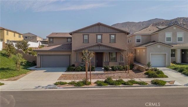 2694 Kings Canyon Dr, Jurupa Valley, CA 92509 - view of front facade featuring driveway, a mountain view, stucco siding, an attached garage, and a porch