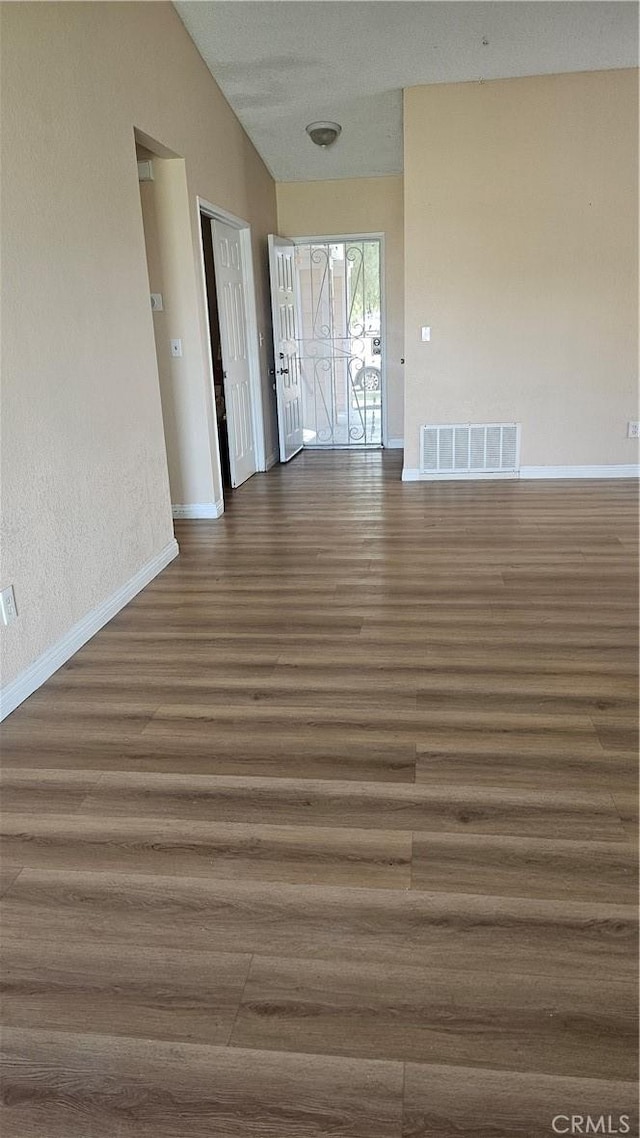 2031 Yucateca St, Perris, CA 92570 - spare room with wood finished floors and lofted ceiling