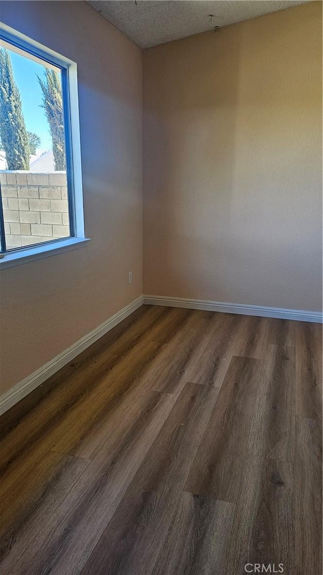 2031 Yucateca St, Perris, CA 92570 - unfurnished room featuring dark wood finished floors and a textured ceiling