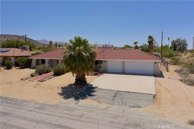 6774 Galleta Ave Unit 29, Palms, CA 92277 - mediterranean / spanish house featuring a tile roof, concrete driveway, a garage, and stucco siding