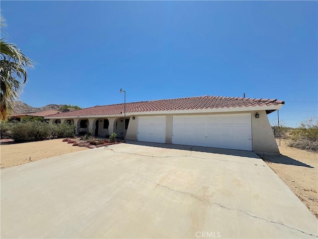 6774 Galleta Ave Unit 29, Palms, CA 92277 - mediterranean / spanish-style home with a tiled roof, concrete driveway, a garage, and stucco siding