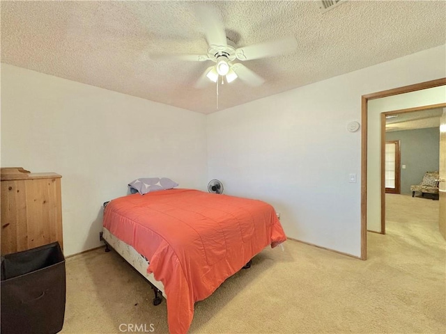 6774 Galleta Ave Unit 29, Palms, CA 92277 - bedroom featuring light carpet, a textured ceiling, and a ceiling fan